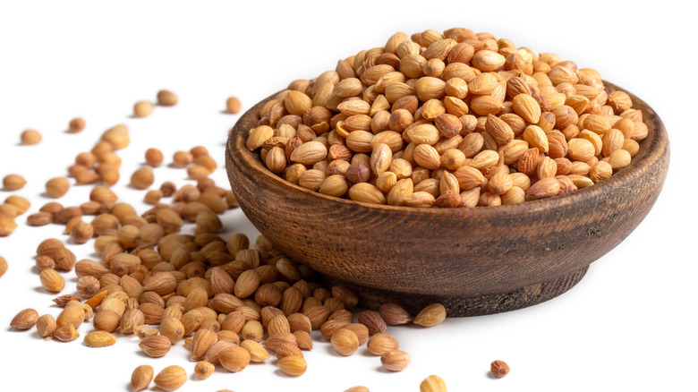 A bowl of mahlab seeds on a white background