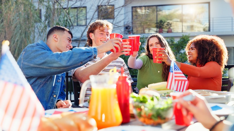 group of friends cheering with solo cups