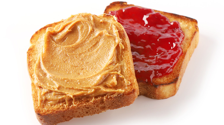 two slices of bread, one with peanut butter, the other with jelly