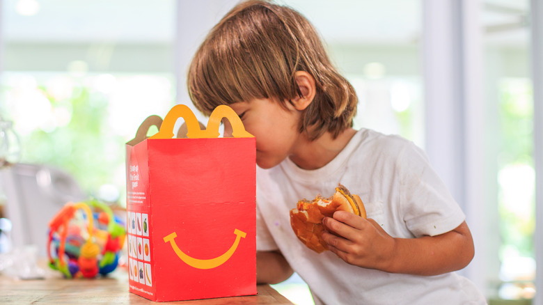 A child peers into a McDonald's Happy Meal box