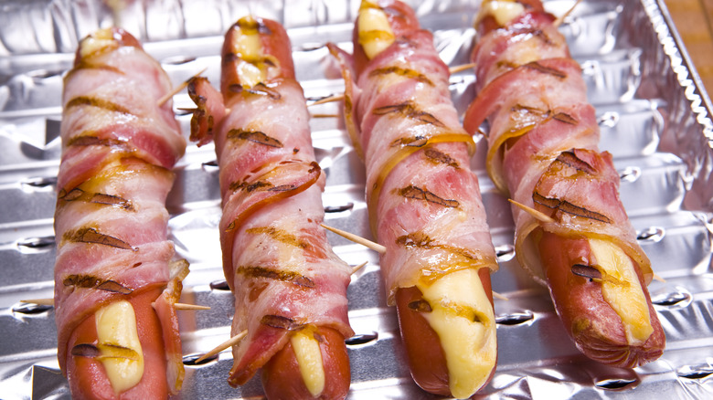 Grilled frankfurter wrapped in bacon
