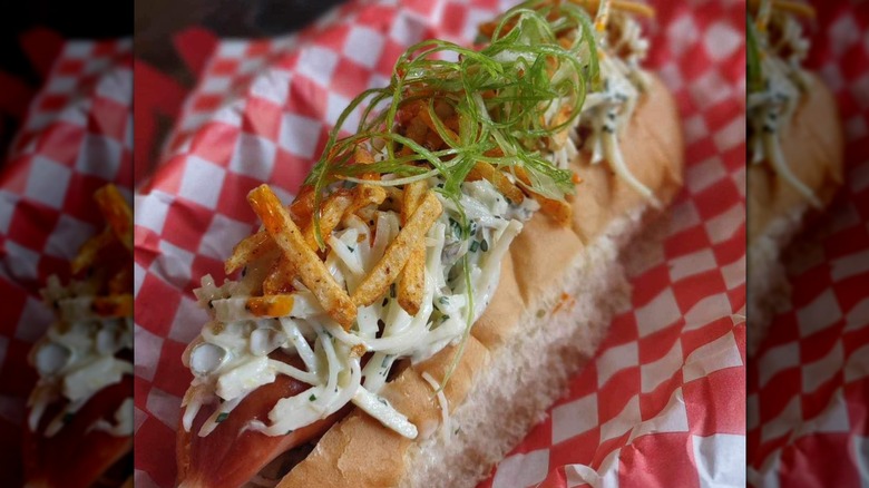 A close-up of a hot dog topped with celeriac remoulade