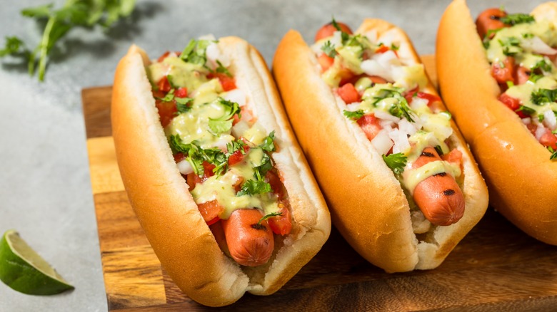 A close-up of a hot dog topped with salsa