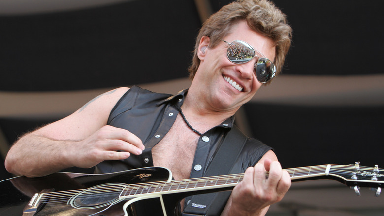 A close-up of John Bon Jovi on stage in sunglasses