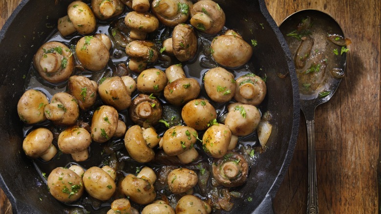 sauteed mushrooms and onions in a pan