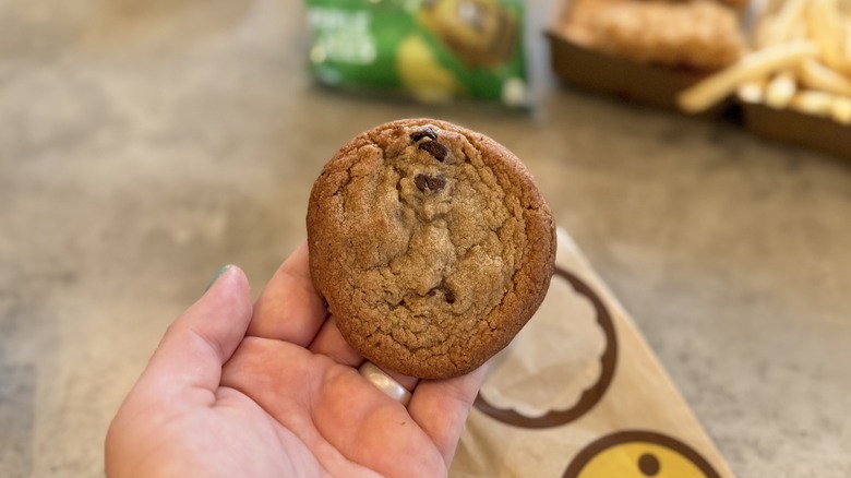 Holding McDonald's cookie at lunch