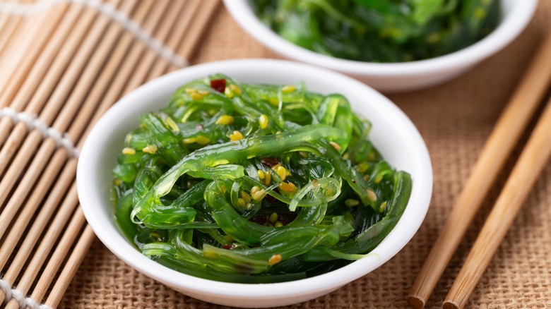 edible wakame seaweed in a bowl with sesame seeds