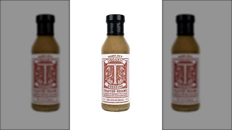 embellished bottle of sesame dressing with black cap