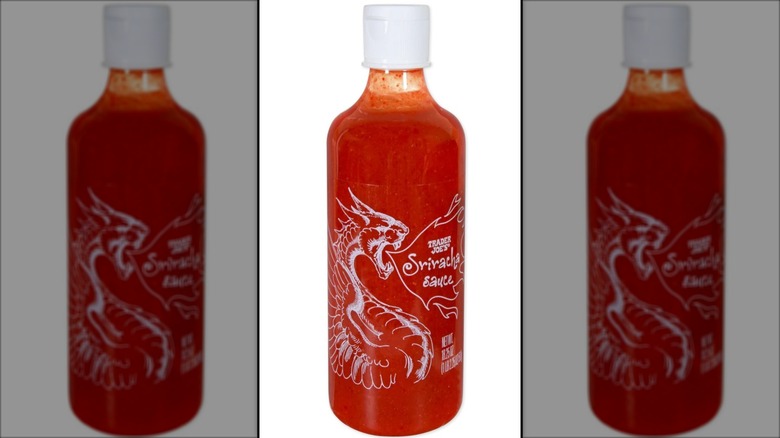 bottle of red sriracha adorned with dragon