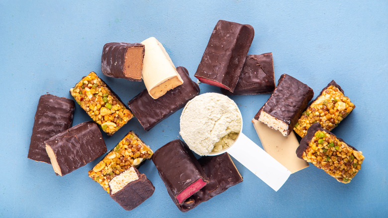 assortment of protein bars and protein powder