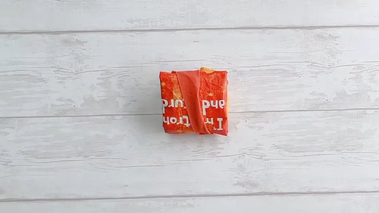 Closeup of reusable grocery bag folded into square.