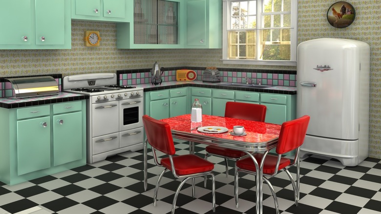 a colorful 1950s-style kitchen with mint green cabinets