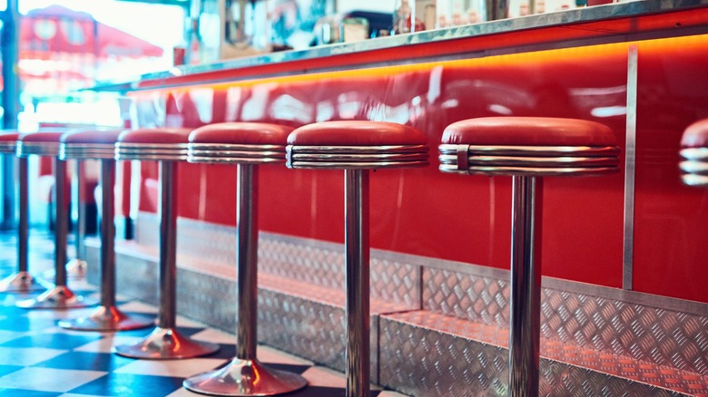 barstools and checkerboard floor in a retro diner