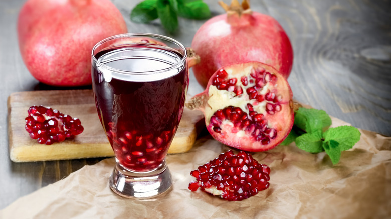 A glass of pomegranate juice and fruit