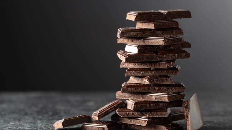 stack of dark chocolate shards against black background