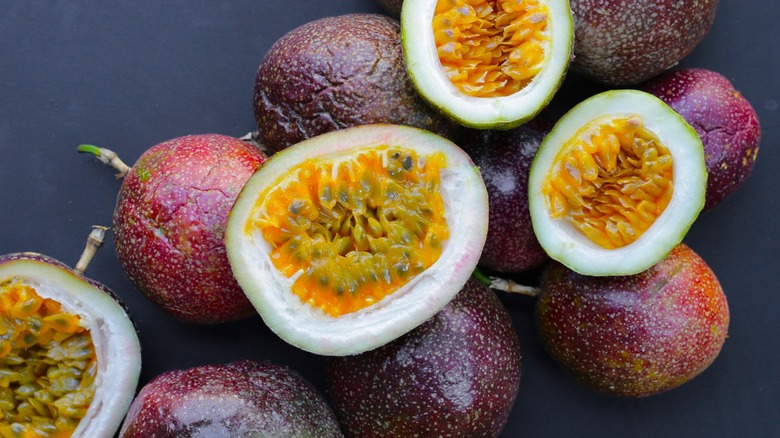 ripe passion fruits on black surface