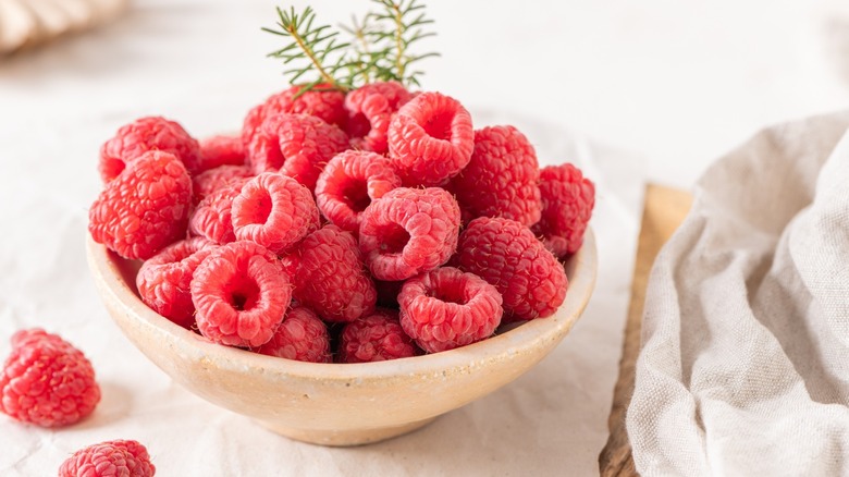ceramic bowl of juicy raspberries