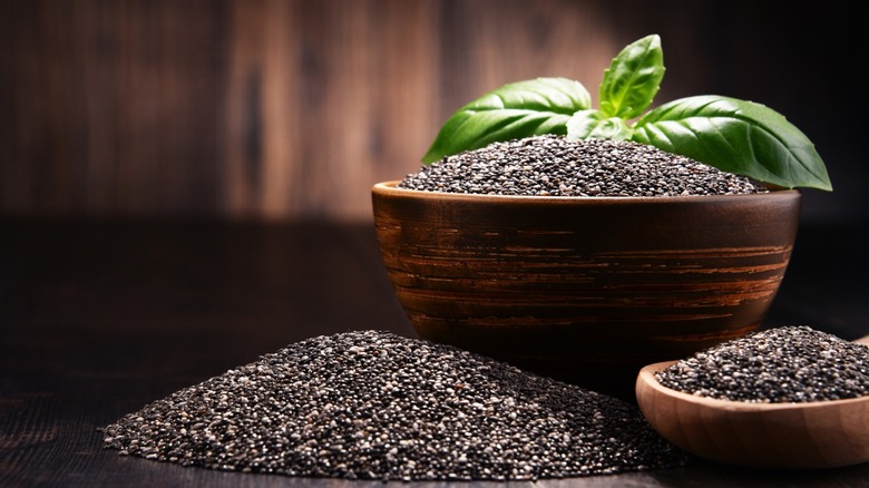 wooden bowls of chia seeds with leaves