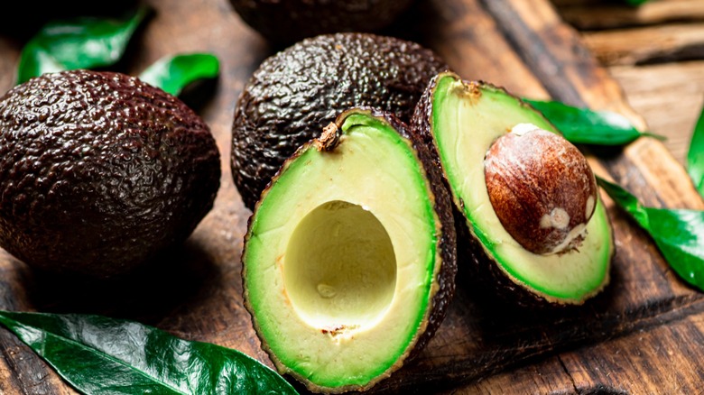 ripe avocados cut open to show pits