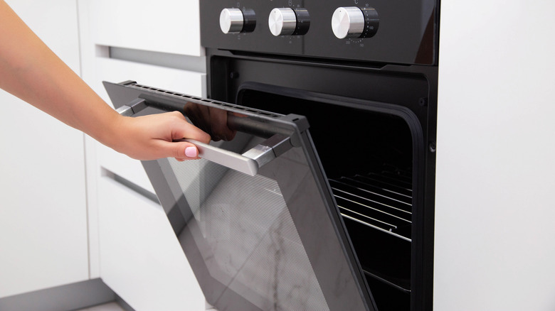 Someone opening an oven door
