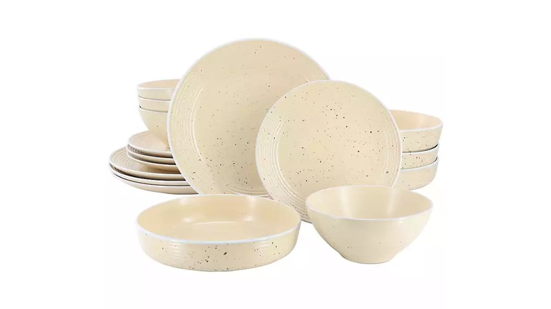 speckled cream dinnerware set white background