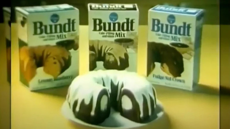 Lineup of three vintage Pillsbury Bundt Cake Mixes with finished Bundt cake in foreground
