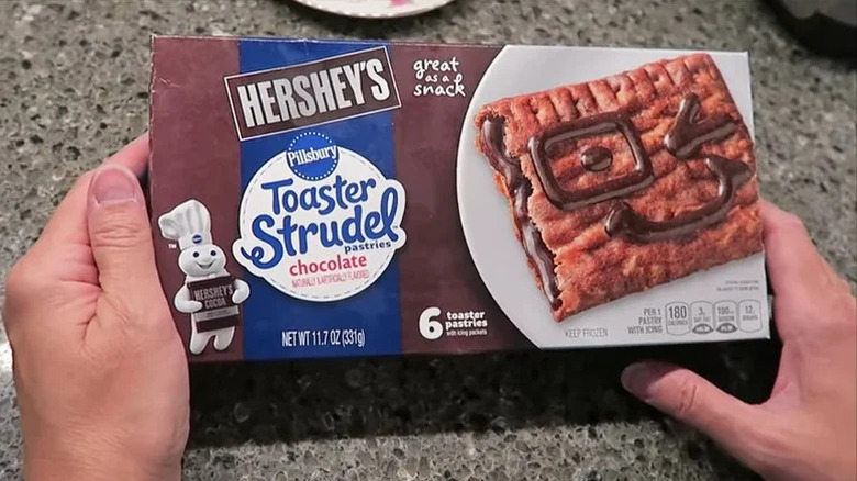 Hand holding box of Pillsbury Hershey's Chocolate Toaster Strudel