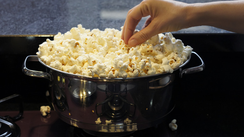 A stainless steel pan full of popcorn