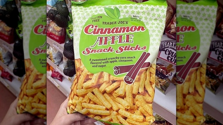 Hand holding bag of Trader Joe's Cinnamon Apple Snack Sticks