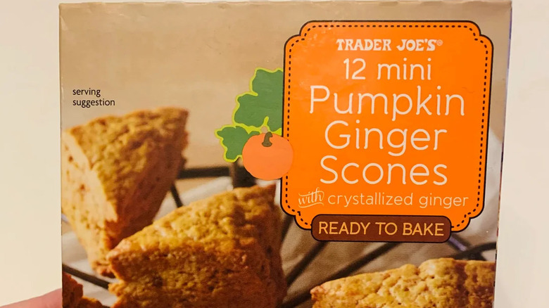 Hand holding box of Trader Joe's Mini Pumpkin Ginger Scones