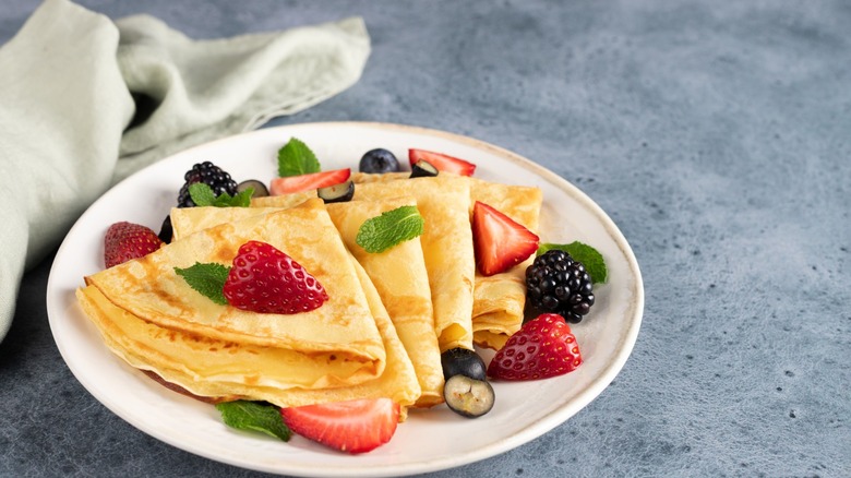 crepes on a platter with berries