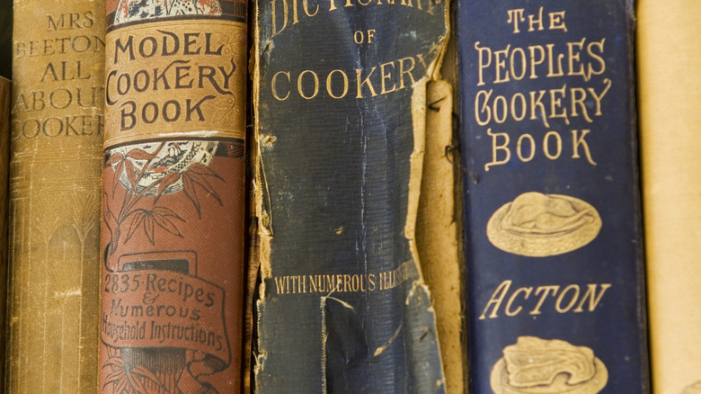 Close-up of several vintage cookery book spines