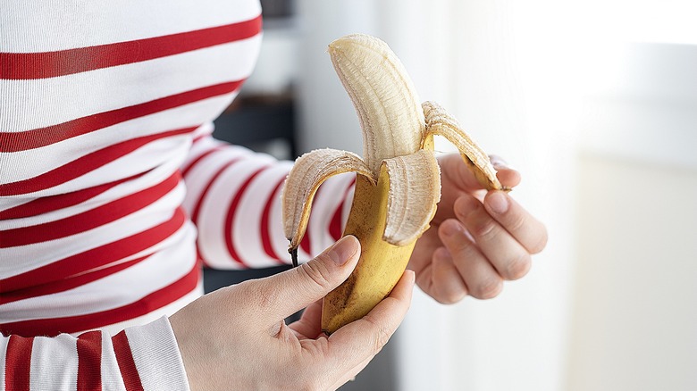 a person peels a banana