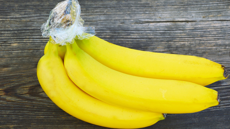 Bananas with plastic wrapped around stem