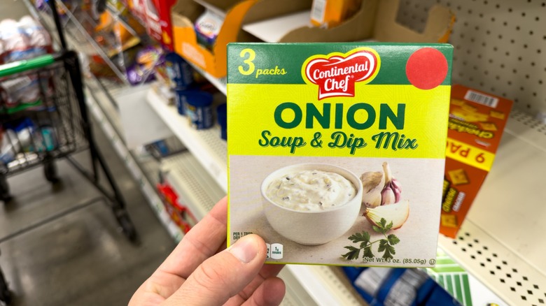 hand holds box of onion soup mix in store