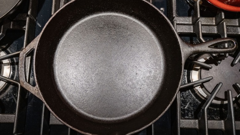 seasoned, gleaming cast iron pan on gas stove