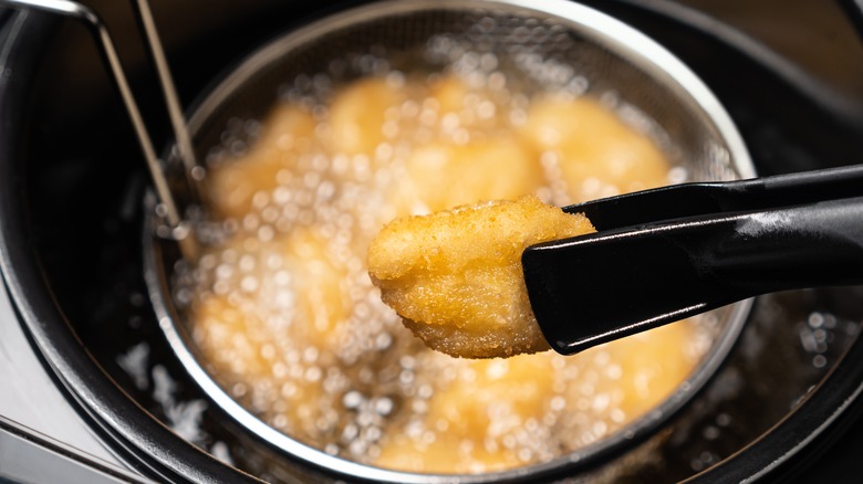 chicken nuggets being deep fried