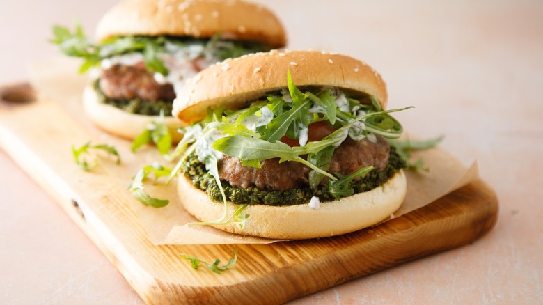 pesto burgers with arugula and sesame bun