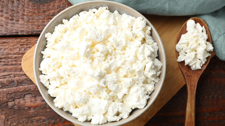 cottage cheese in bowl with wooden spoon