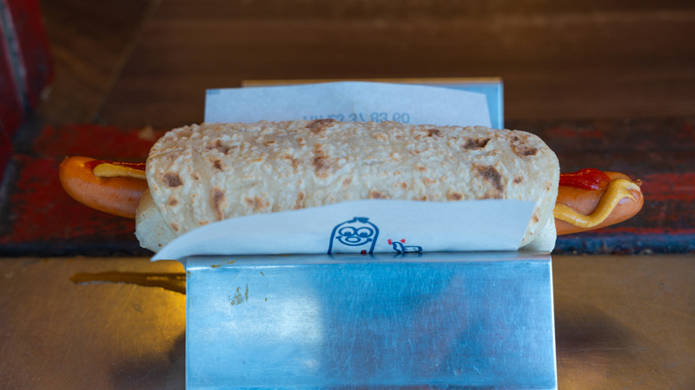 Norwegian-style hot dog served in Oslo with mustard, ketchup, wrapped in flatbread