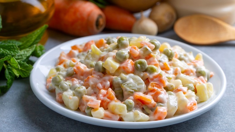 olivier salad on plate with spoon