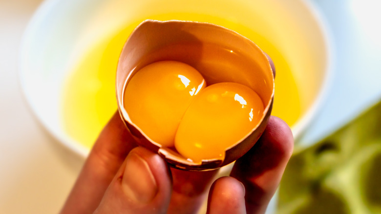 close view of double yolk inside cracked egg