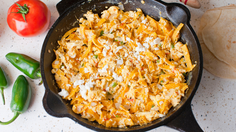 A pan of scrambled eggs with fried tortilla chips