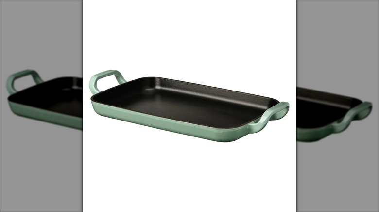 Green griddle with two handles and black nonstick interior