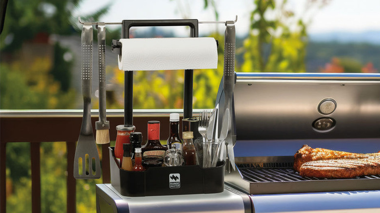 Caddy for a gas grill with utensils and condiments