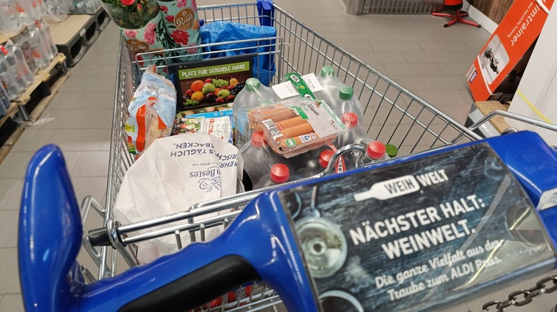 a full shopping cart in an aldi store aisle
