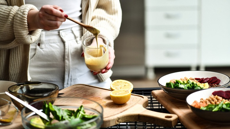 Person using spoon in homemade dressing