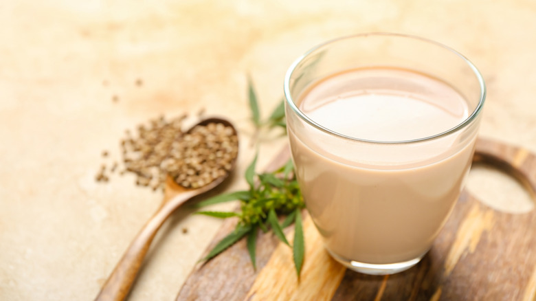 Close-up of a glass of healthy hemp milk on light background