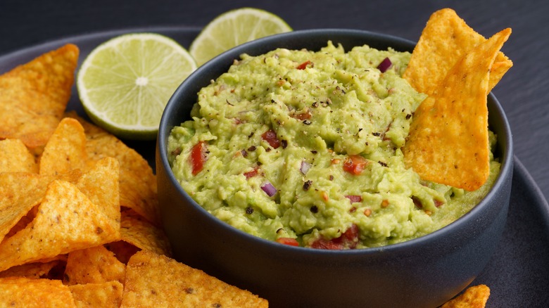 Guacamole with tortilla chips and limes