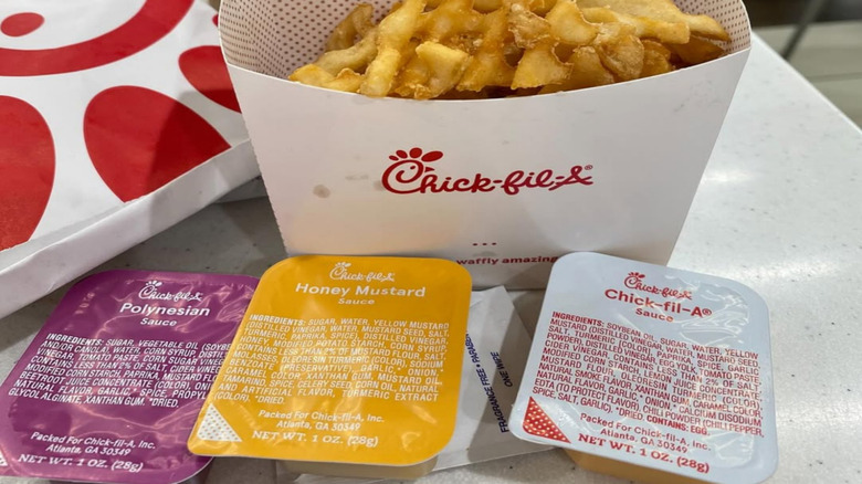 Chick-fil-a waffle fries and sauce containers closeup